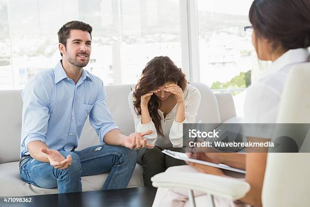 Couple Fighting Together In Front Of Their Therapist Stock Photo - Download Image Now