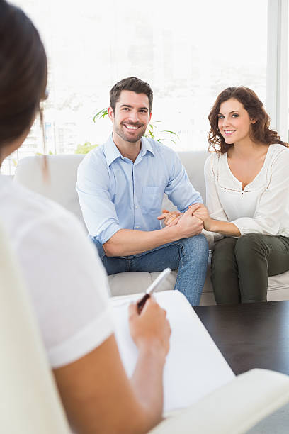 istock Reconciled couple smiling on couch 471098538