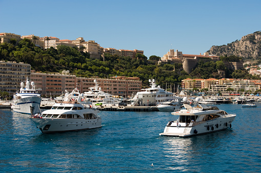 View of the busy activity of luxury yachts in Monaco Monte Carlo harbour