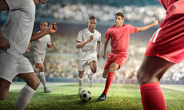 istock Soccer player kicking ball in stadium 471099532
