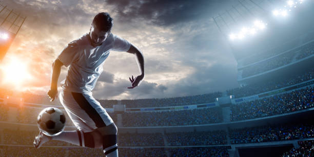 istock Soccer player kicking ball in stadium 471099592