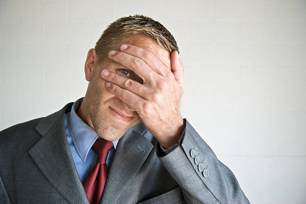 istock Nervous Businessman Peeking Through Fingers 471099893