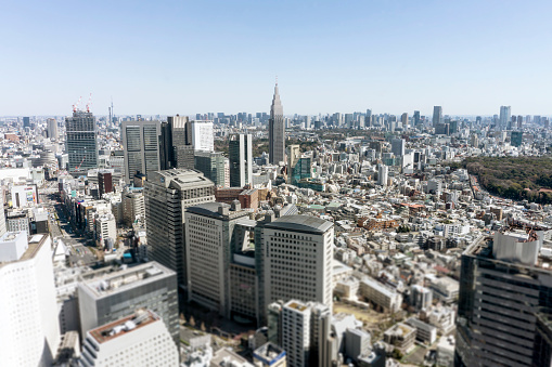 The city skyline of Tokyo, the capital city of Japan. Large skyscrapers dominate the vast cityscape.