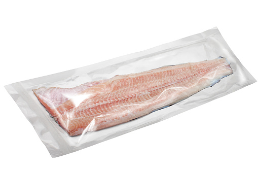 Fish fillet in package on white