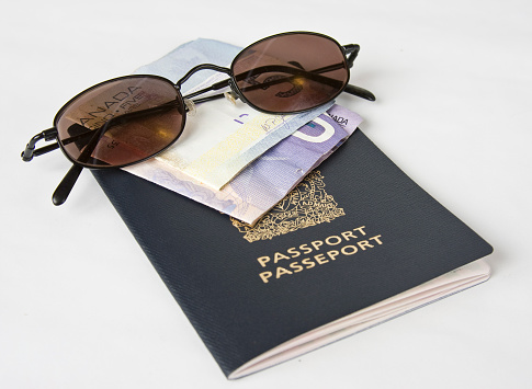 Wallet,Money,Glasses and passport laid out on display