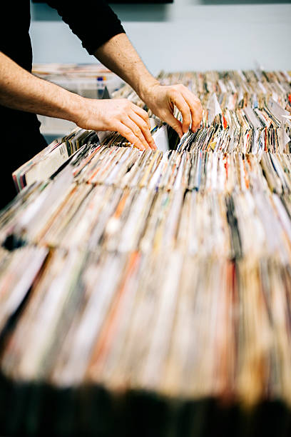 istock Searching through second hand vinyl records in a record store 471100864