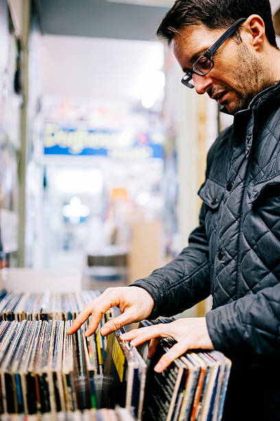 istock Man searching for second hand vinyl records, record store 471101666