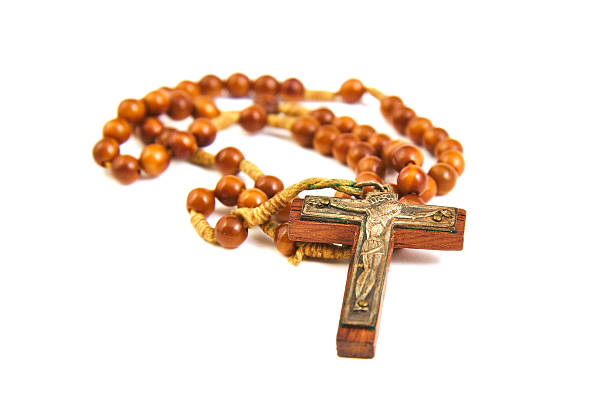 istock Wood rosary and cross with slightly unfocused beads isolated on 471101918
