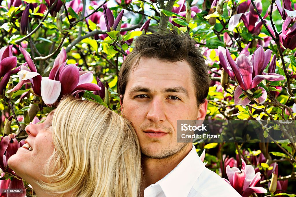young spring couple young couple in spring, magnolia blossom... Couple - Relationship Stock Photo