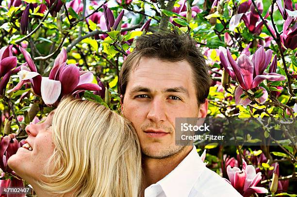 Young Spring Couple Stock Photo - Download Image Now - Couple - Relationship, Magnolia, 20-29 Years