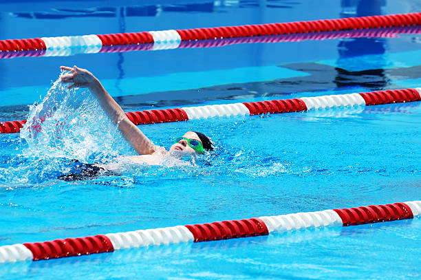 istock Young Boy Swimming Backstroke in Race 471104483