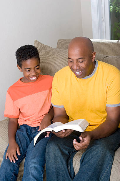 istock Father and son reading the bible 471105083