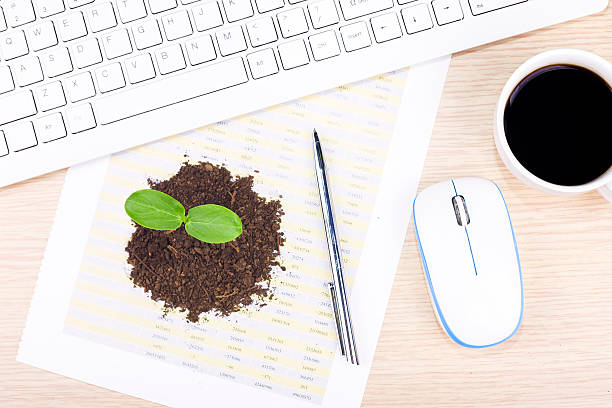istock Bussiness investment:plant and keyboard with coffee on desk 471105310