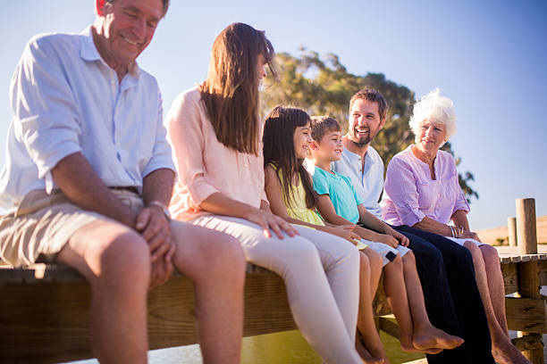 istock Three generation family relaxing together on a jetty 471105860