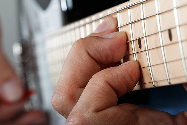 istock Hands of man playing electric guitar 471106594