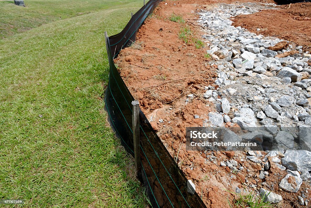 Silt fence erosion control barrier at construction site Silt fencing with soil backed up against it to show erosion control effectiveness Erosion Control Stock Photo