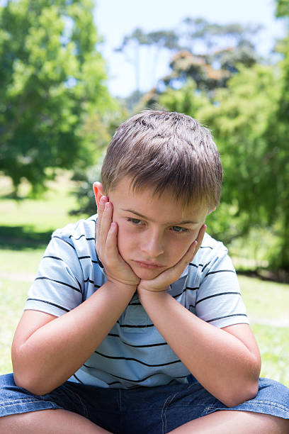 istock Little boy feeling sad in the park 471108936