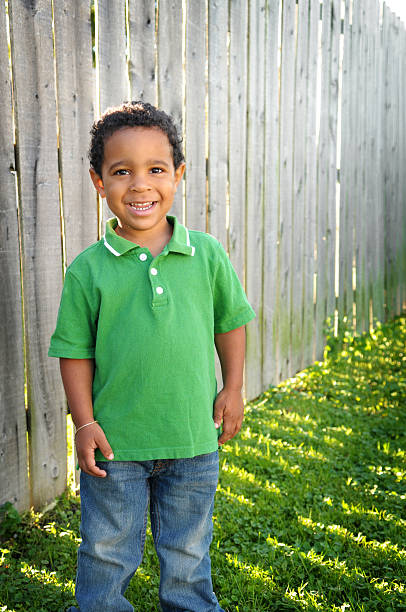 istock Happy Little Boy Smiling Outside by Fence 471110525