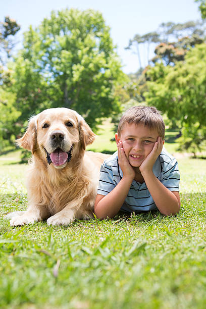 istock Little boy with his dog in the park 471111006