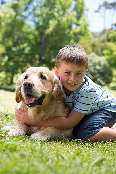 istock Little boy with his dog in the park 471111026