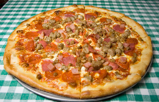 Cheese pizza with sausage, ham, pepperoni and hamburg