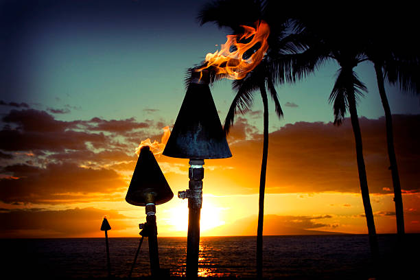 istock Fire torches against a beautiful island sunset 471111373