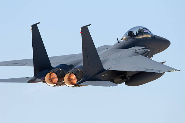 Rear view of a jet fighter in flight stock photo