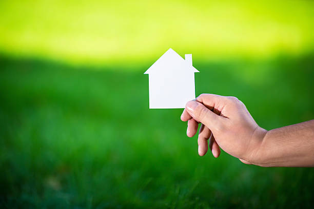 istock Conceptual image for home renting with hand holding a house 471112466