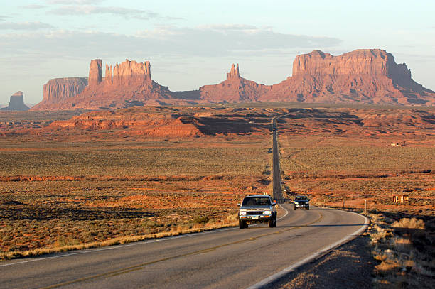 рассвет на долина монументов - desert road desert road landscape стоковые фото и изображения