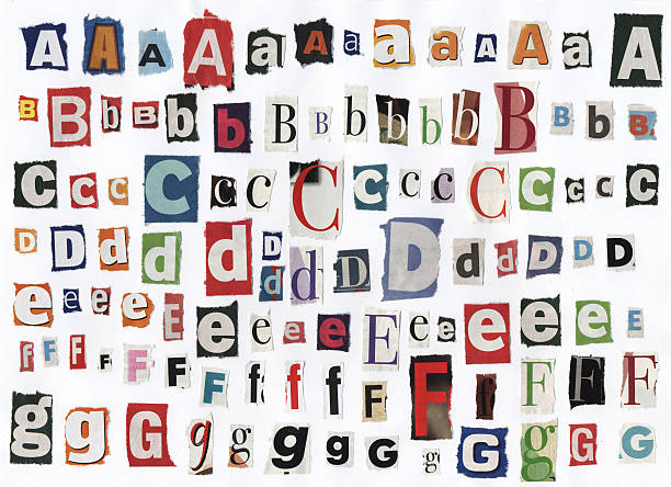 Different alphabet letters cut out of newspaper stock photo