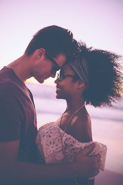 istock Loving mixed race couple on a beach at sunset 471113328