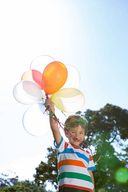 istock Happy little boy holding balloons 471113746