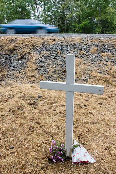 istock Cross at vehicle accident site 471114895