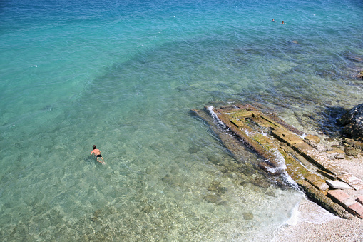 Aerial view of people swimming in the sea near Paleokastritsa, corfu, Greece.
