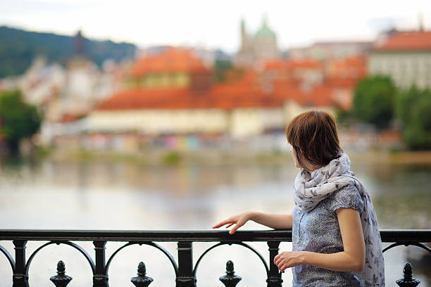 istock Woman looking at the Prague Castle 471115808