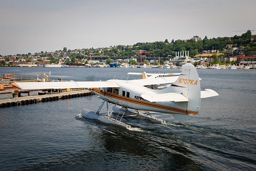 Seaplanes landing and moving to the Parking Pier of Lake Union in Summer. Seattle, USA.