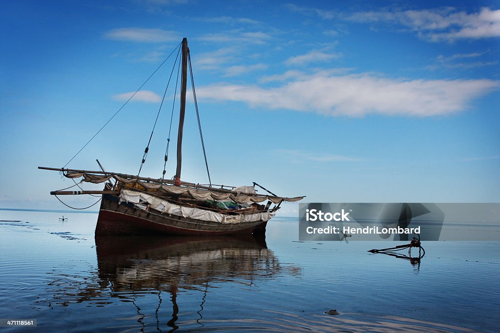 anchored boat An anchored fishing boat on the coast of mafia island Anchor - Vessel Part Stock Photo