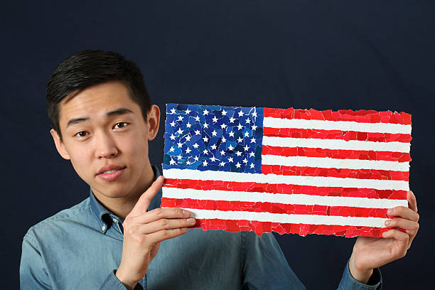 istock Young Asian student showing US national flag 471118812
