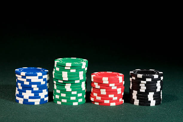 Gambling concept - chips in four color stock photo