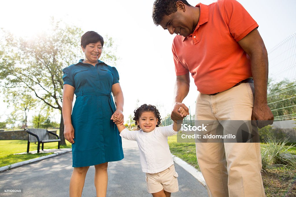 Happy grandparents with granddaughter Happy grandparents with granddaughter in a park Family Stock Photo
