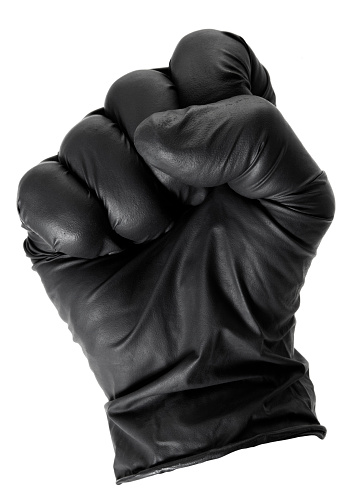 Human fist wearing a black latex glove isolated on white.
