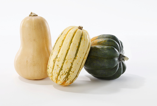 Still Life of three gourds photographed on a white background.