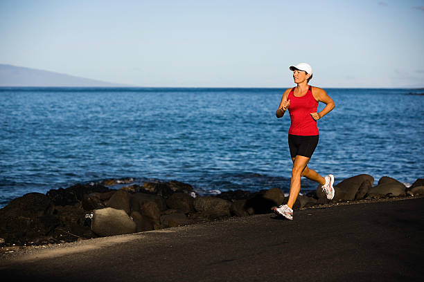 istock Woman running near the water 471123861