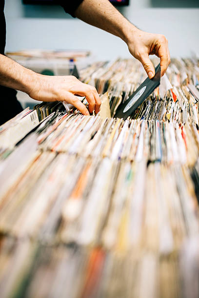 istock Second hand vinyl records in a record store, hands searching 471124124