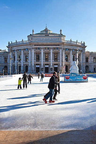 Ice skaters in front of the Burgtheater of Vienna Vienna, Austria - January 31, 2015: Ice skating people at the Wiener Eistraum (ice rink). burgtheater vienna stock pictures, royalty-free photos & images