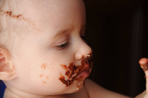 istock Baby enjoying first chocolate cake 471124289