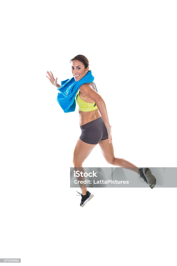 Portrait of happy sporty woman jogging Full length side view portrait of happy sporty young woman jogging. She is in sports clothing. Fitness model is isolated on white background with copy space at bottom. 2015 Stock Photo