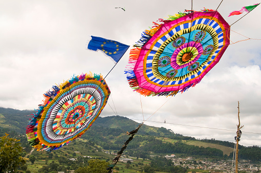 A kite falling on the widely popular dia de los muertos celebration in Santiago, Sacatepequez Guatemala. Special kites are flown on this date at the cemetery to honor the loved ones. It is a very popular place for tourists, too. 