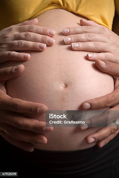 Four Hands On Belly Of Pregnant Woman Stock Photo - Download Image Now - Adult, Adults Only, Affectionate