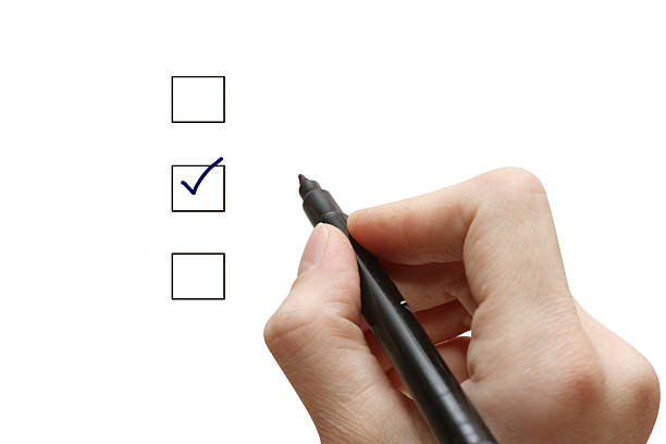 istock Hand with pen selecting one of three choices with tick 471125569